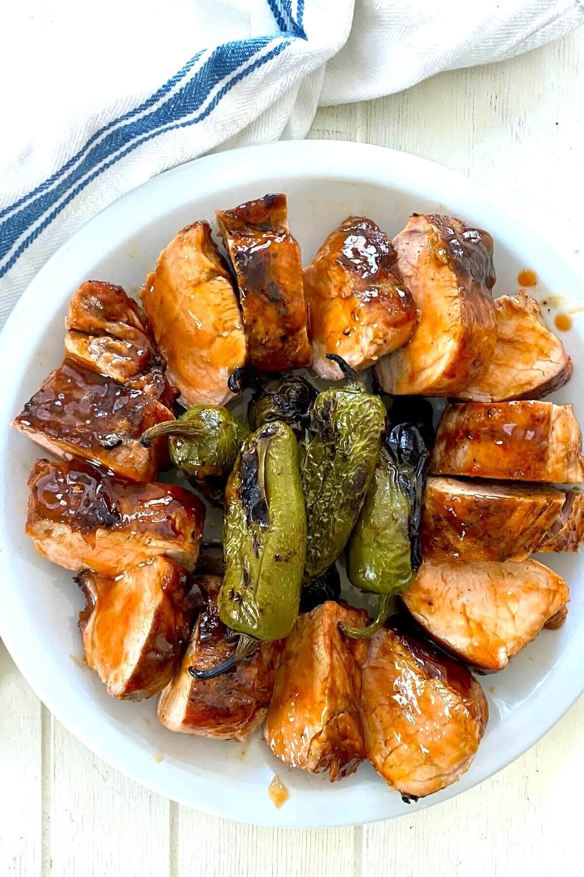 sliced pork tenderloin with grilled peppers.