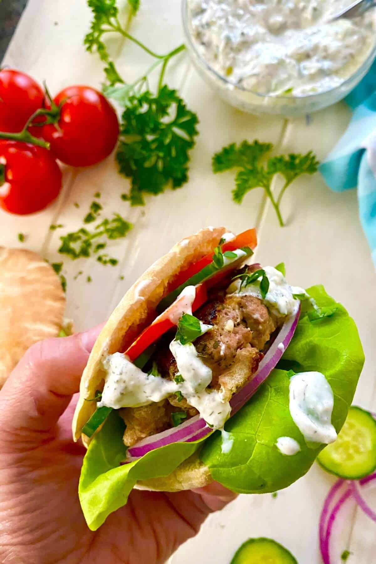 hand holding a turkey burger.