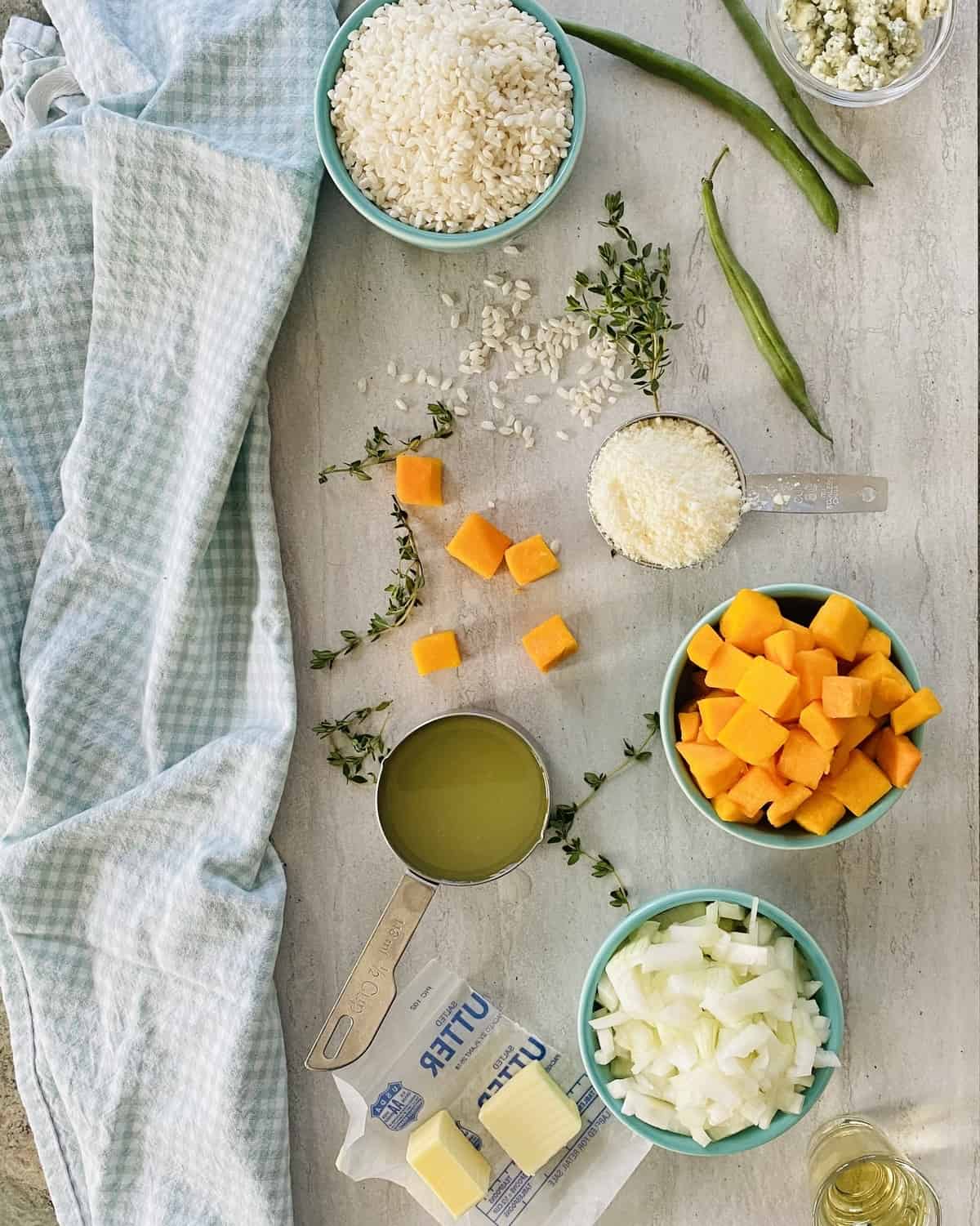 ingredients for an easy risotto recipe - Arborio rice, onion, butternut squash, chicken stock