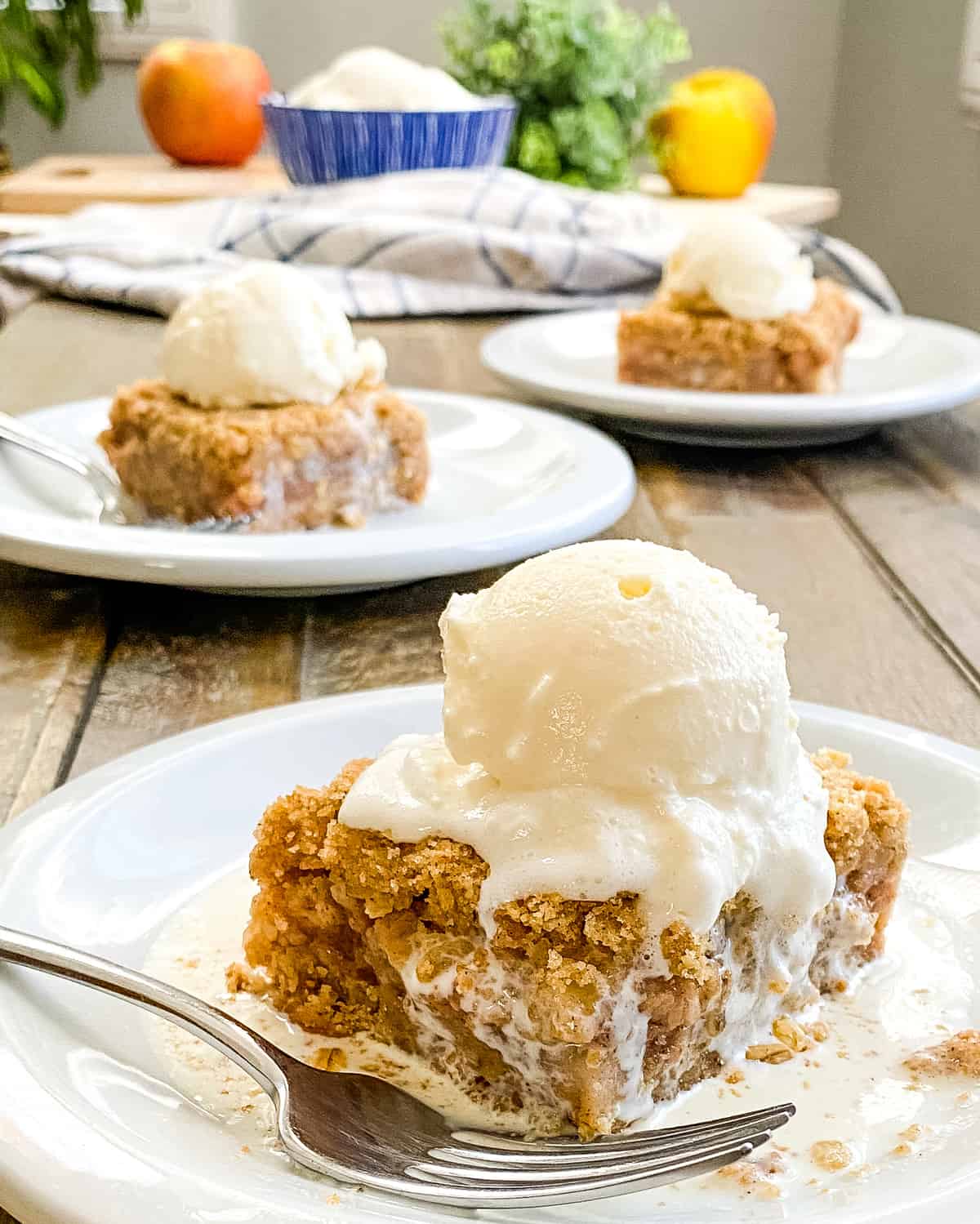 apple crumb bars topped with vanilla ice cream