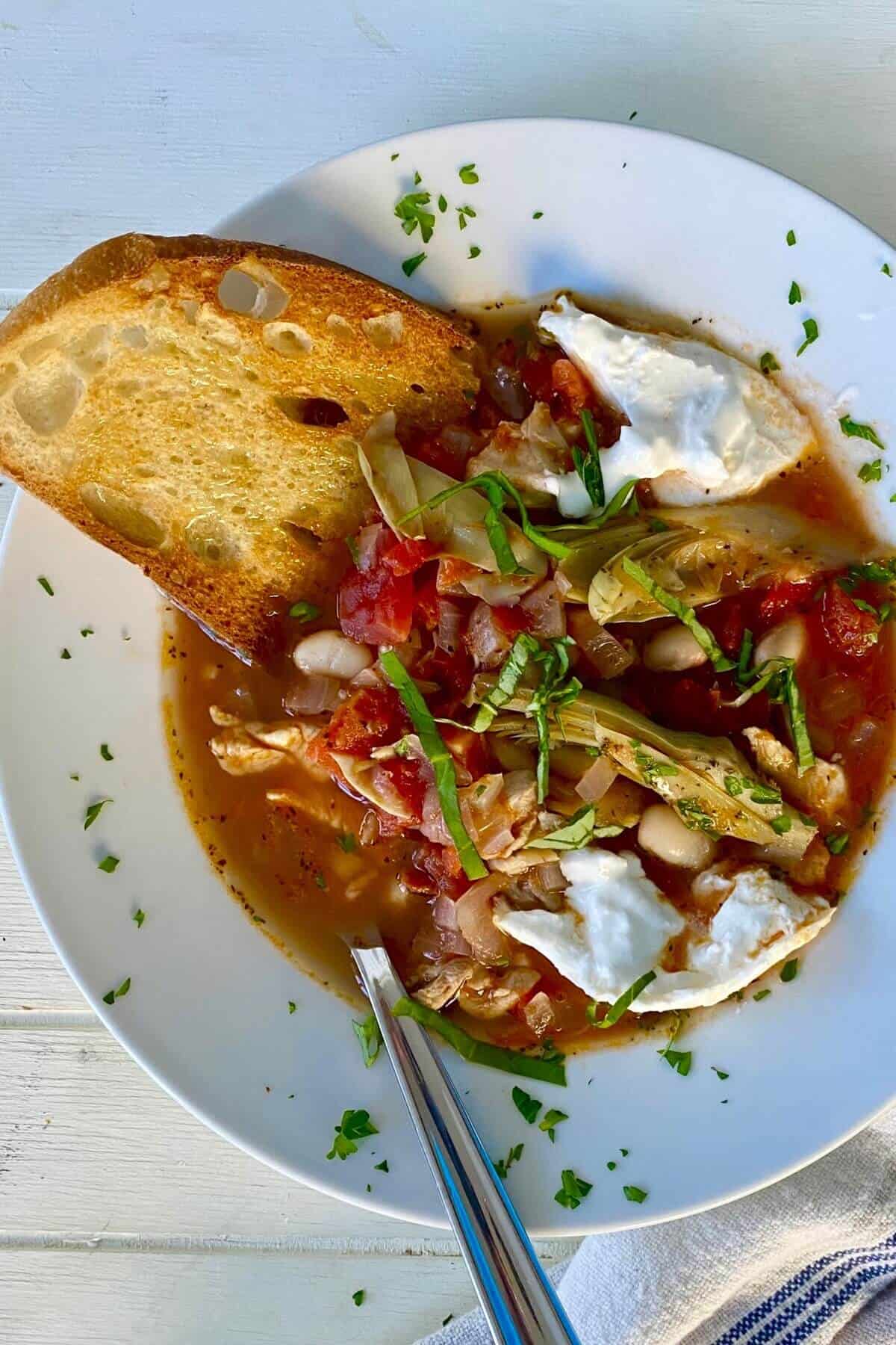 A bowl of Italian chicken soup with burrata.