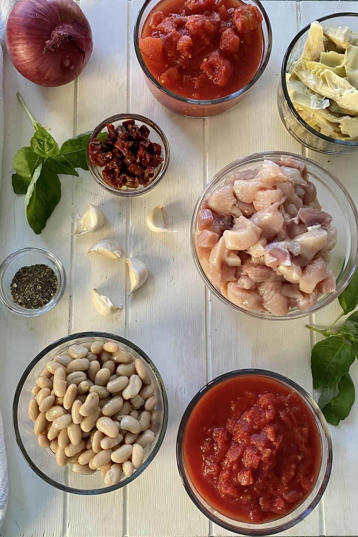 cannellini beans, chicken, toamteos, basil, onion, garlic, spices.