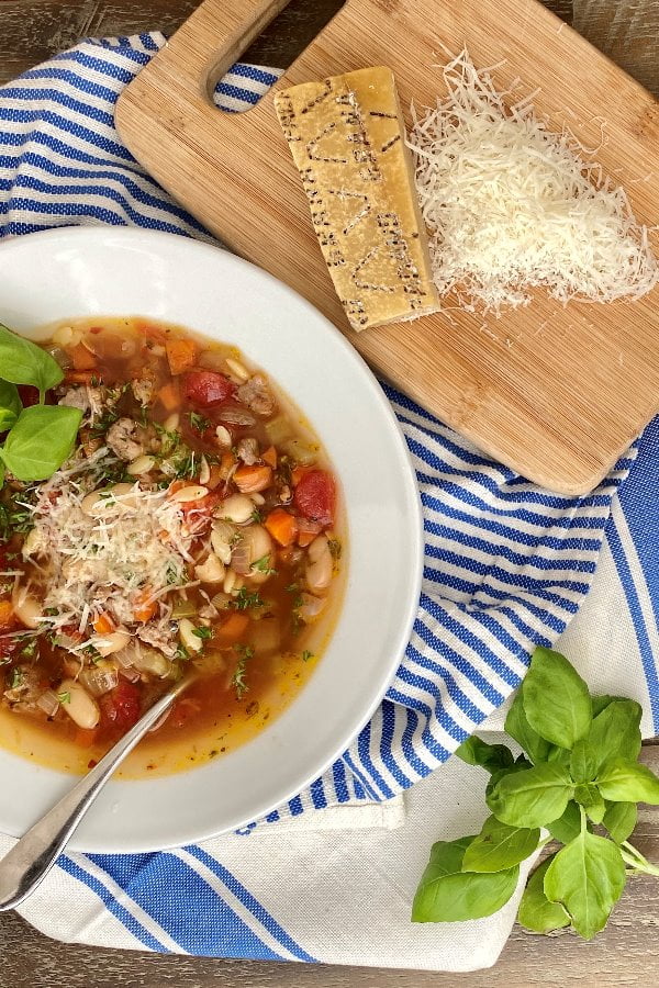 bowl of pasta soup with Italian sausage and vegetables
