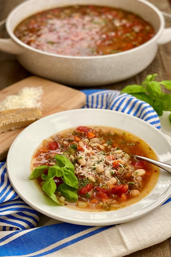 bowl of pasta soup with Italian sausage and vegetables