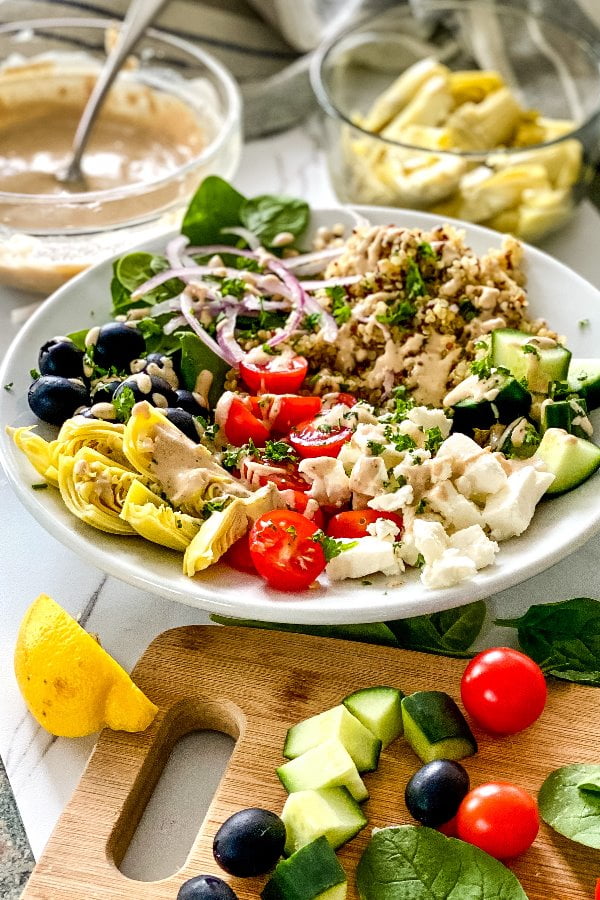 quinoa bowls with artichokes, olives, feta and tahini dressing