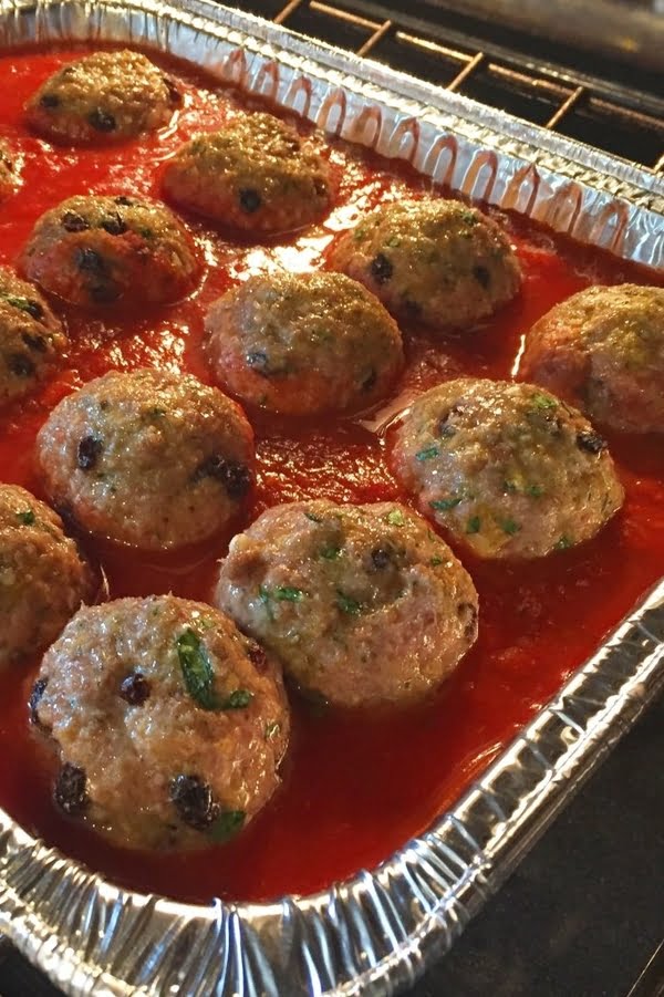 Sicilian meatballs baking in marinara