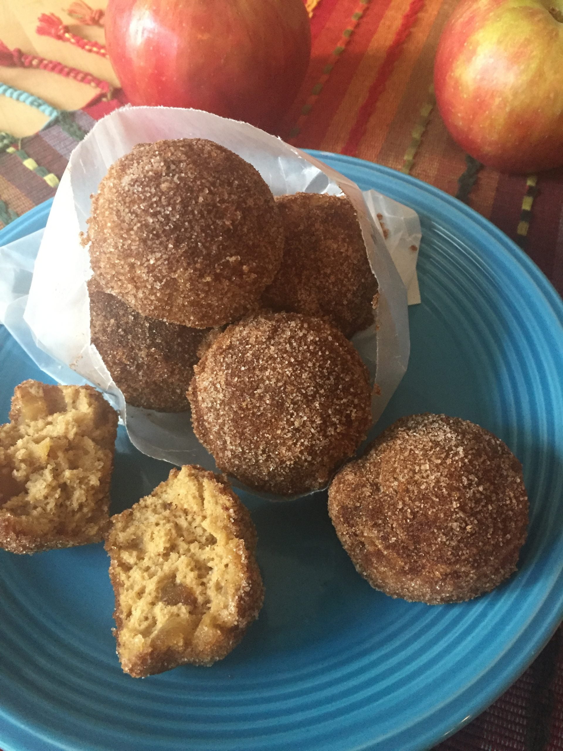 Apple pie donuts on a blue plate.