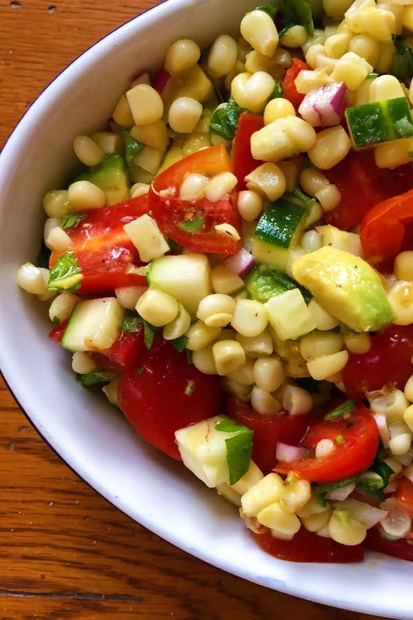 summery salad with corn, avocado, tomatoes and cucumbers