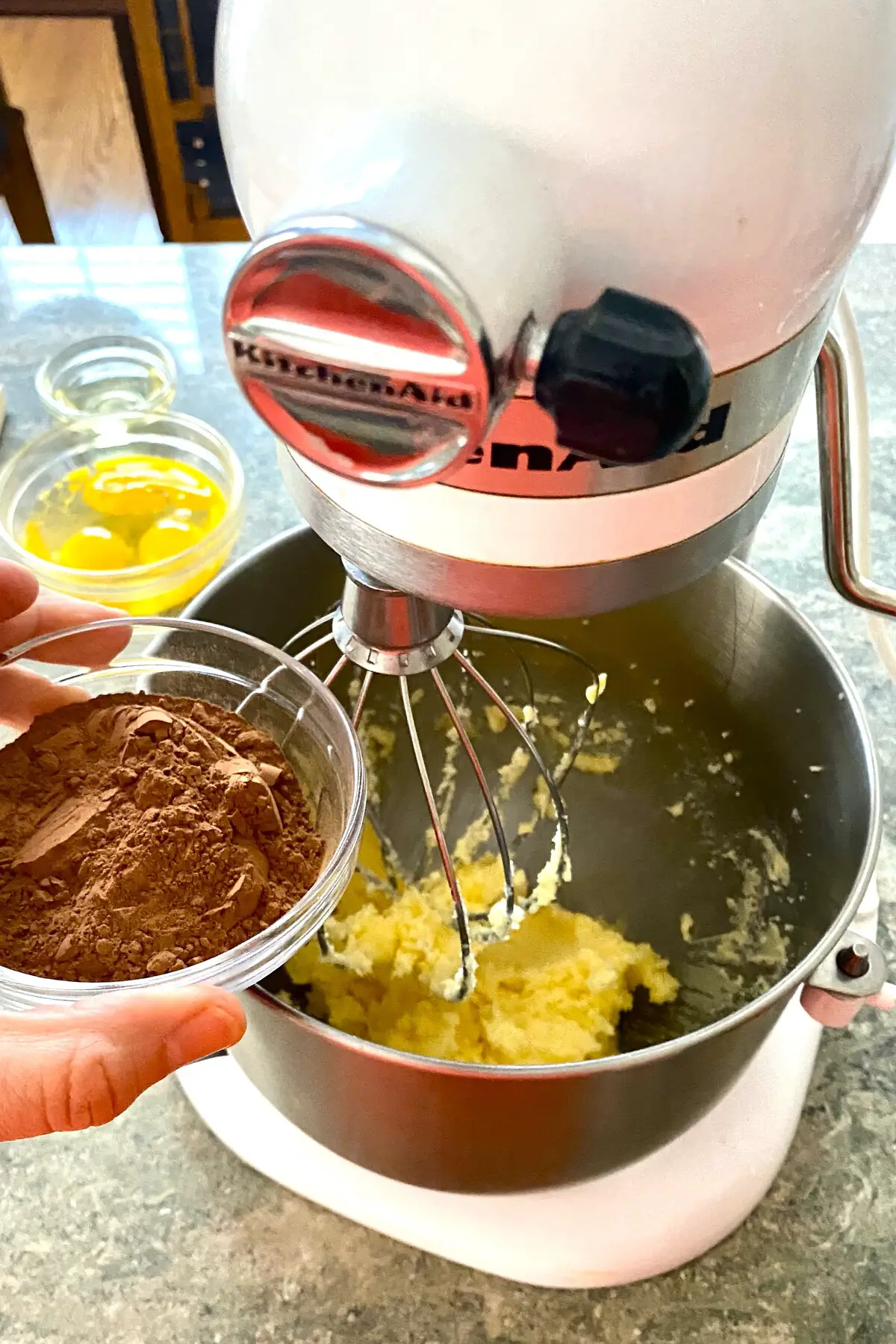 adding cocoa to French silk pie filling in mixing bowl.