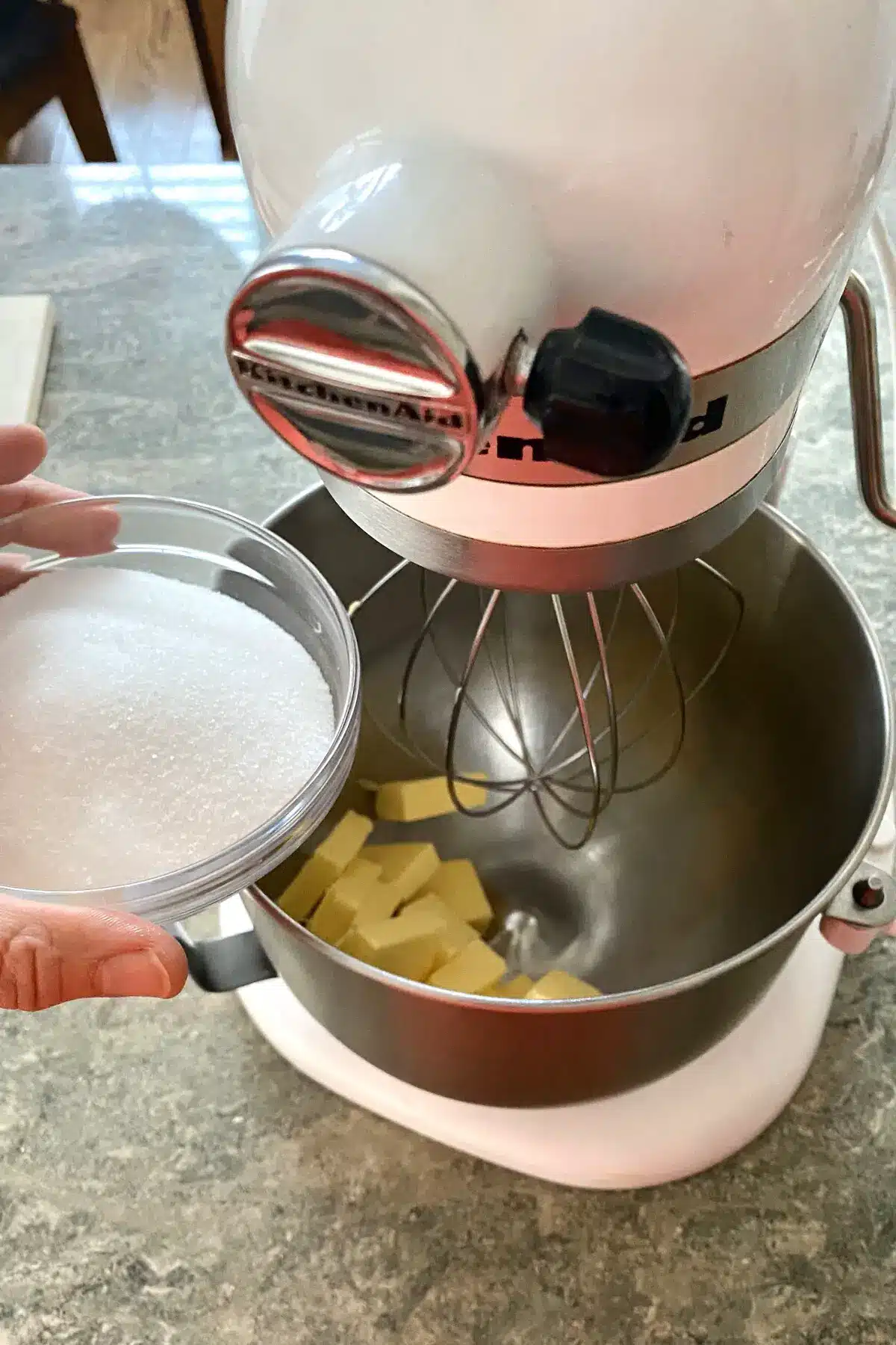adding sugar and butter to mixing bowl.