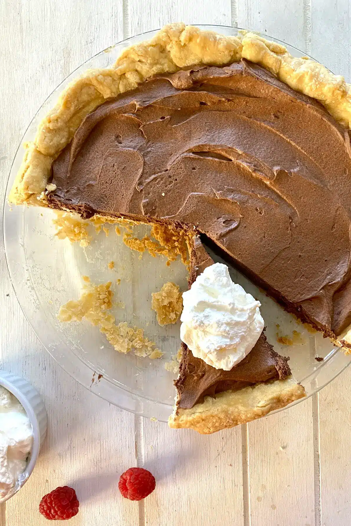 French silk pie with slice with shipped cream.