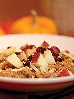 Spiced pumpkin breakfast quinoa topped with chopped apples.