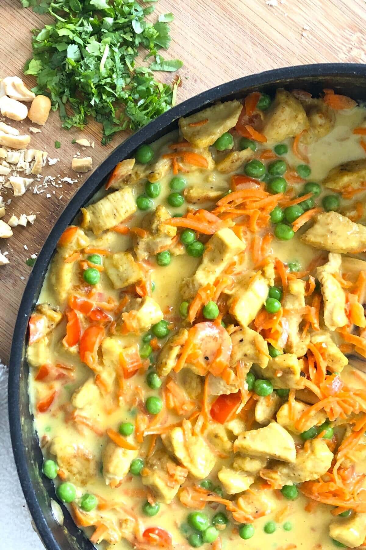 sauté pan with Thai chicken with peas.