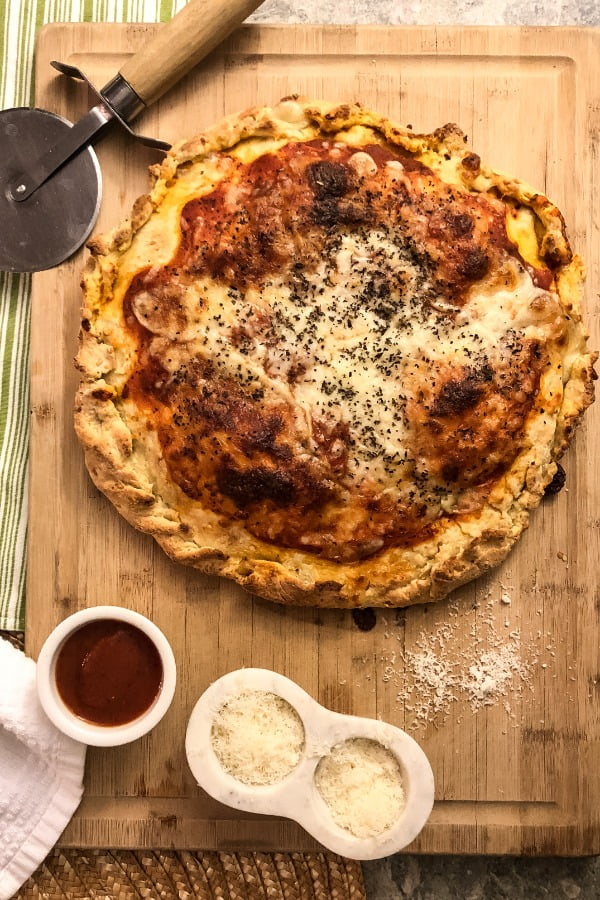 whole stuffed pizza on cutting board
