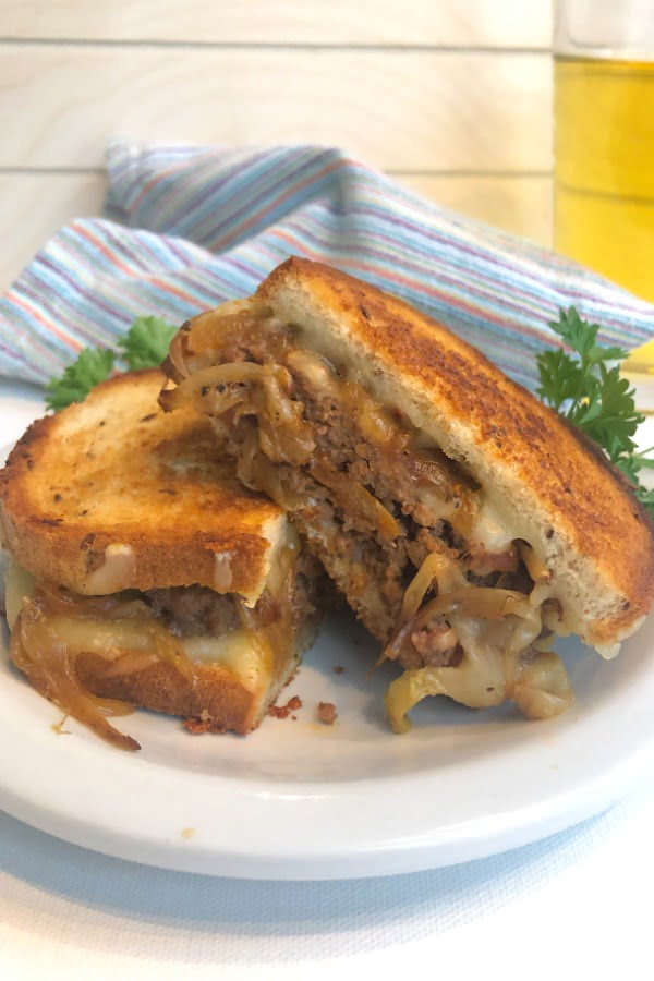 sandwich cut in half with a cold beer