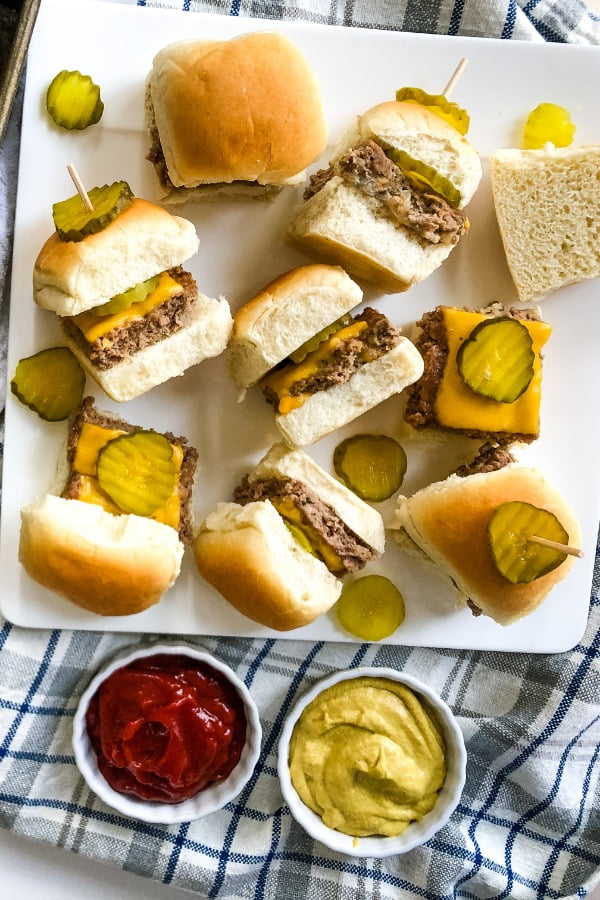 cheeseburger sliders recipe for a plate with 8 sliders with dill pickle chips