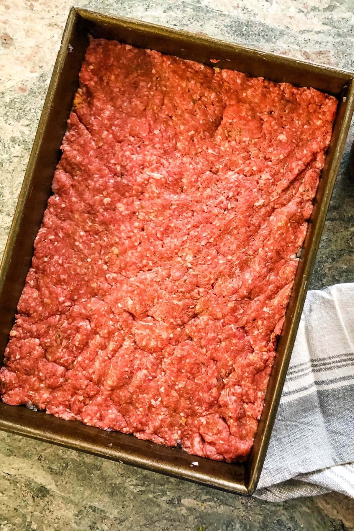 ground beef pressed into pan.