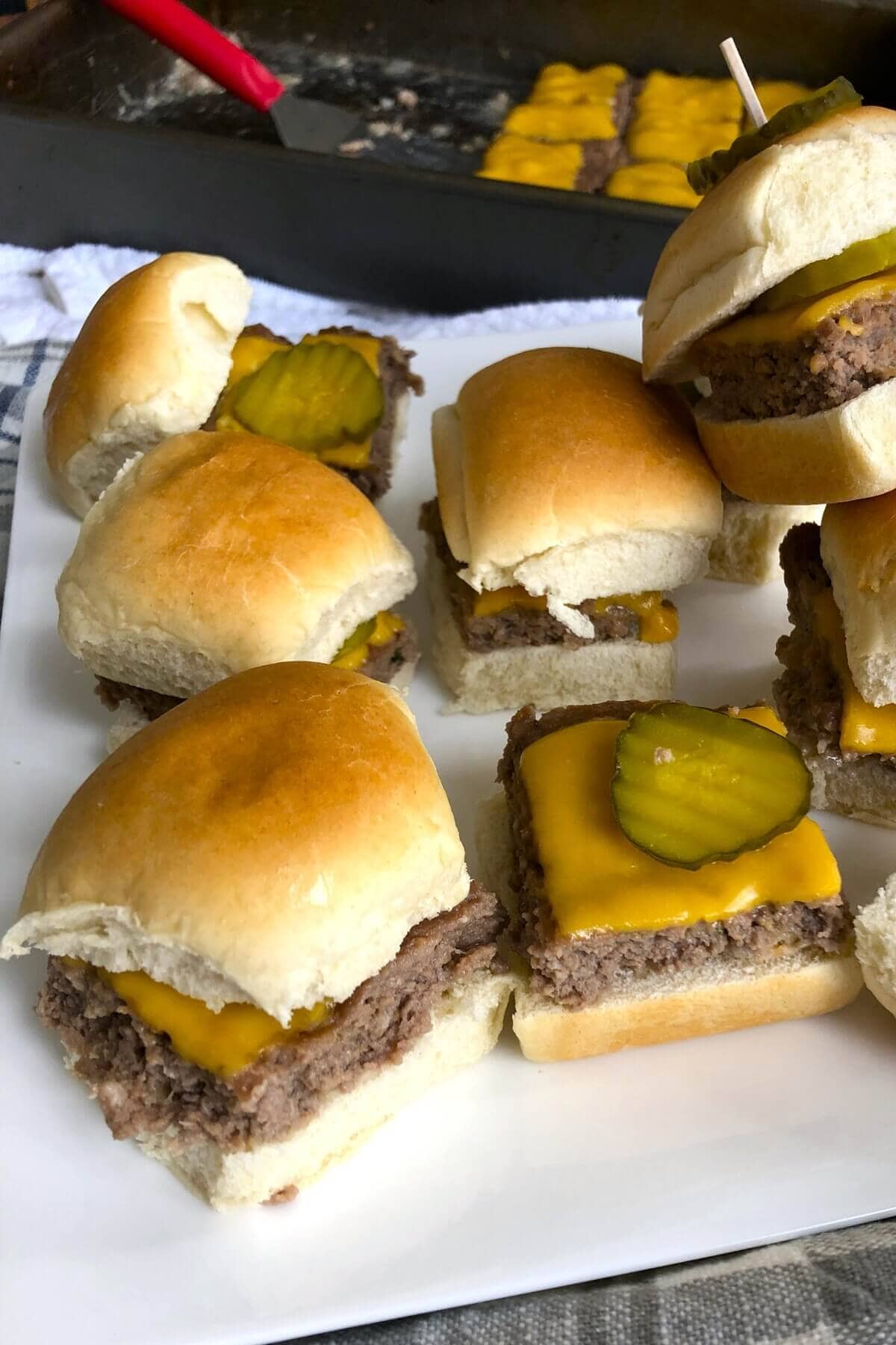 sliders for a crowd stacked on a plate.