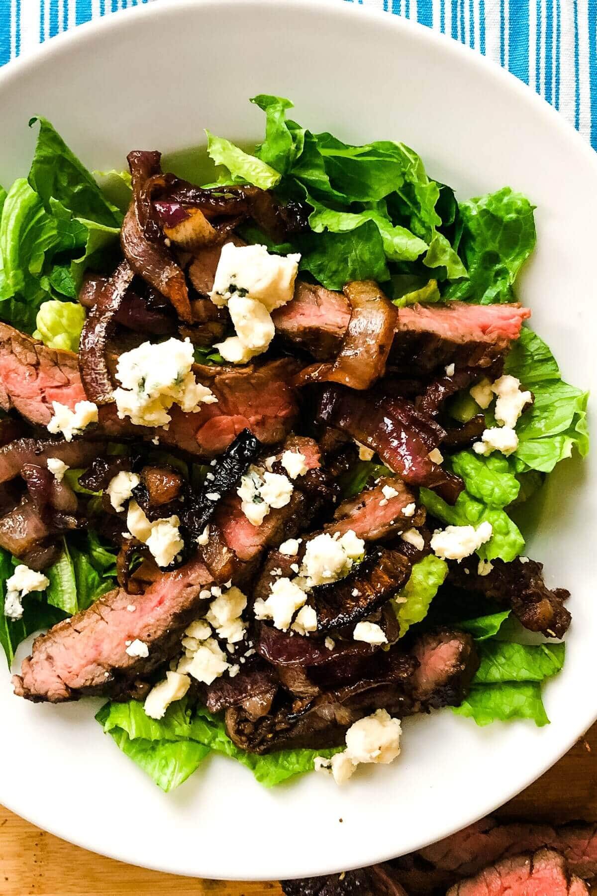 A steak salad recipe with roasted red onions, blue cheese and balsamic vinaigrette.