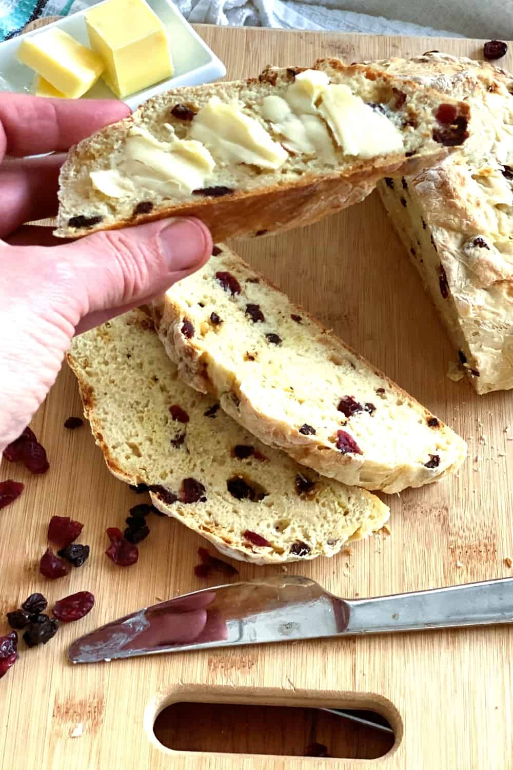 A slice of soda bread with butter.