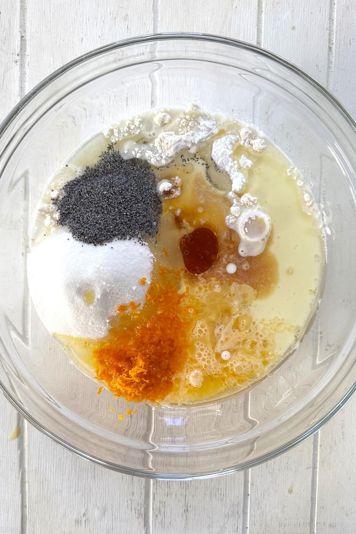 Ingredients for poppy seed muffins in a bowl.