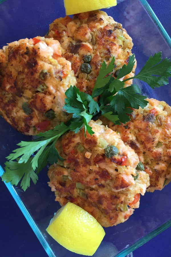 4 salmon patties with lemon wedges