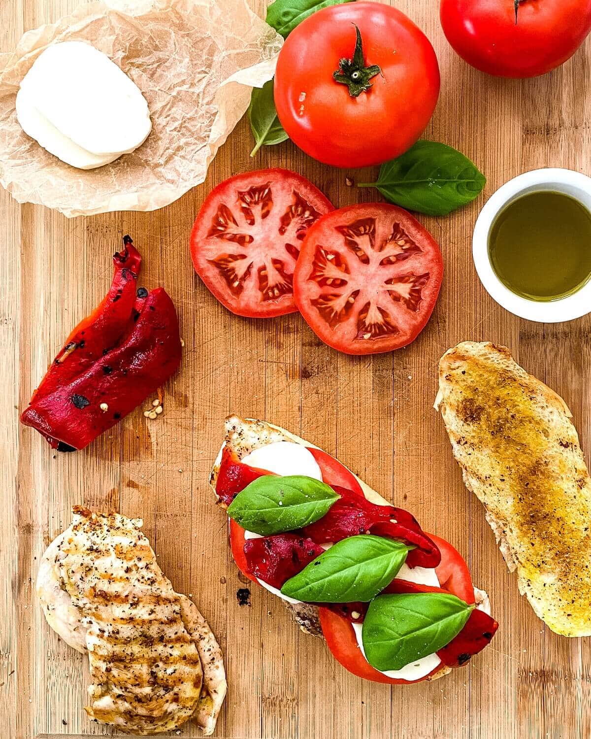Tomatoes, roasted peppers, fresh basil, grilled chicken and a toasted roll.