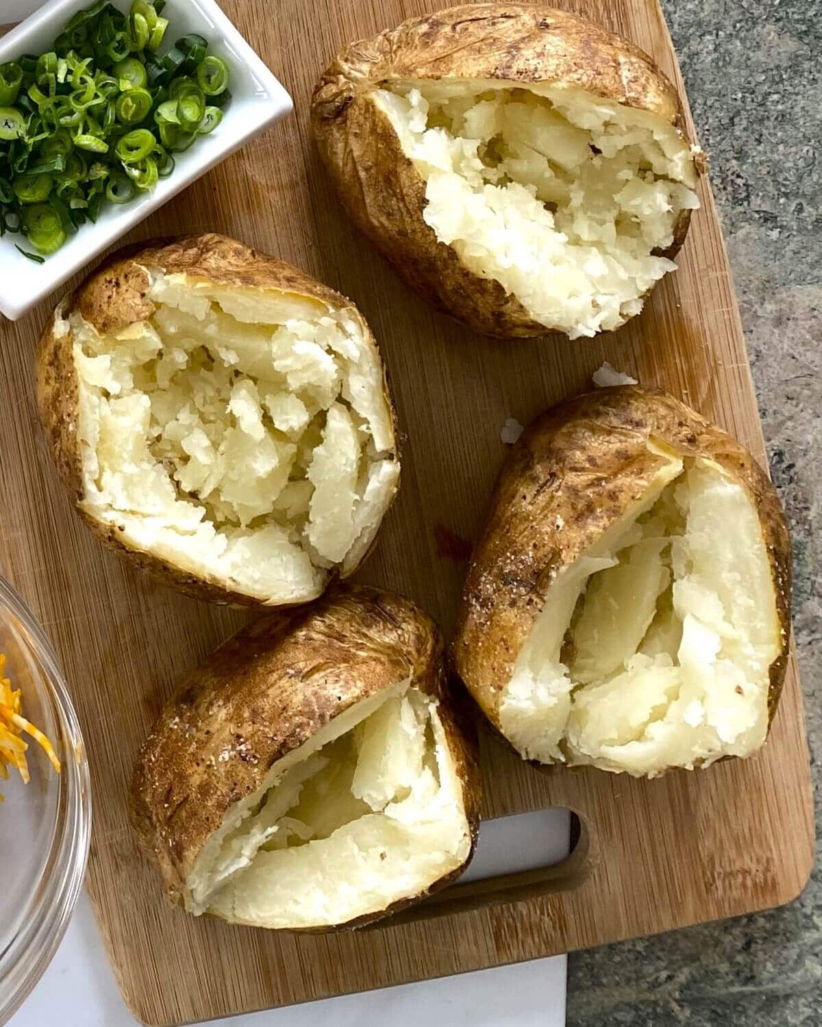 baked potatoes that are cut open.