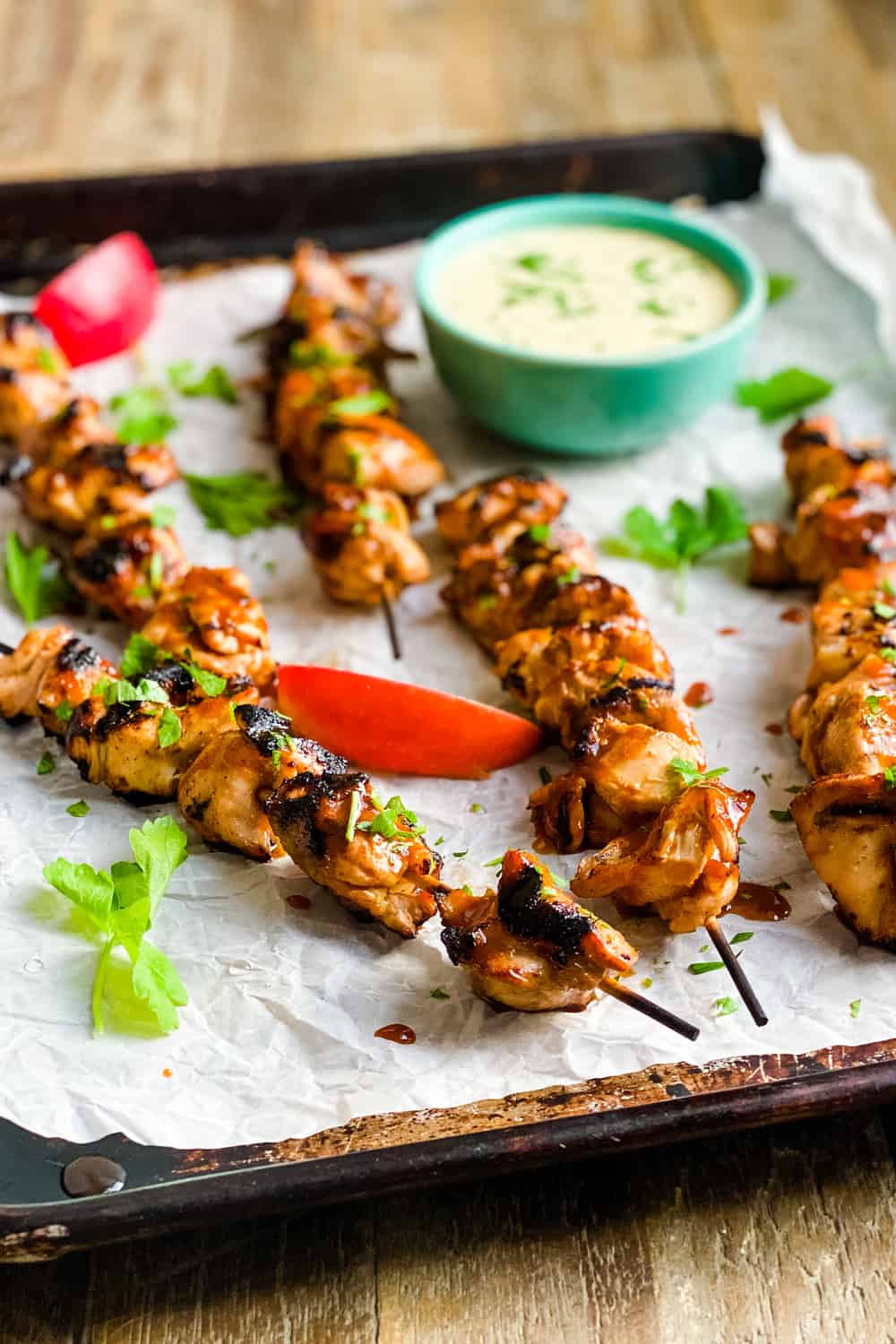 grilled chicken skewers on a baking sheet