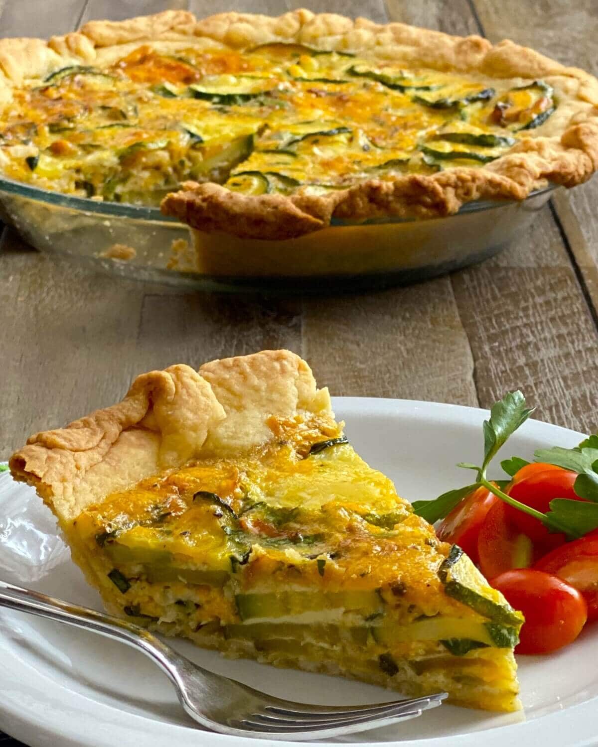slice of zucchini pie with tomato salad.