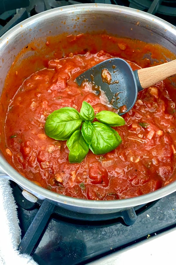 pot of marinara with fresh basil