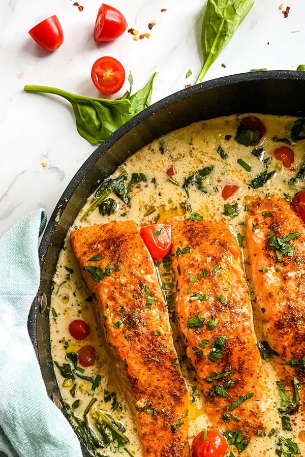 skillet with baked salmon in a coconut sauce - personal chef recipe