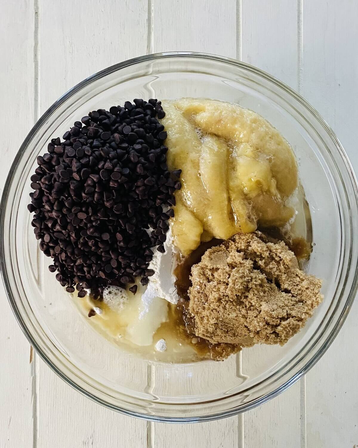 mini chocolate chips, bananas, brown sugar and flour in a bowl.