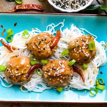 4 spicy general tso's meatballs on a plate