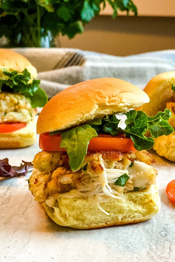 mini crab cake sandwiches with bacon, lettuce and tomato.