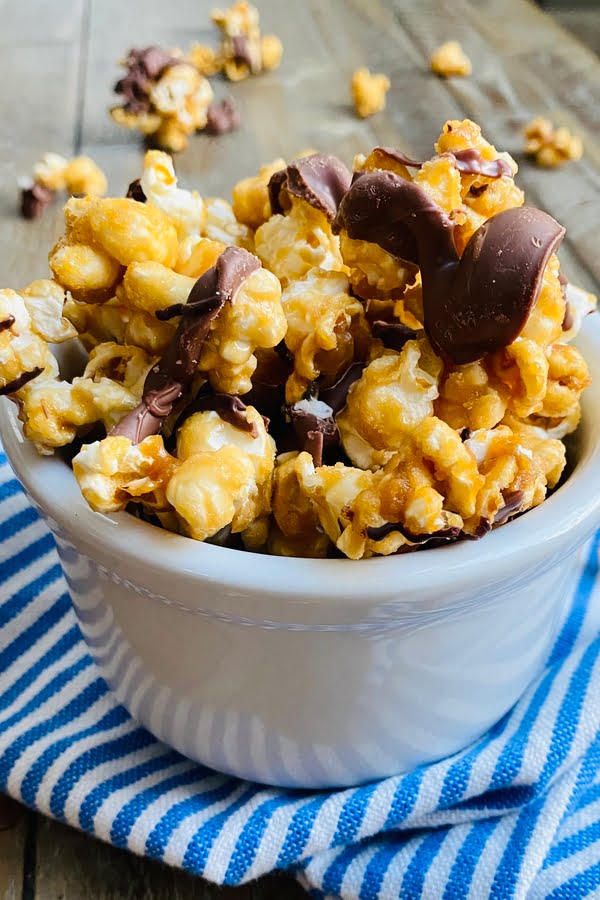 bowl of salted caramel popcorn with chocolate drizzle