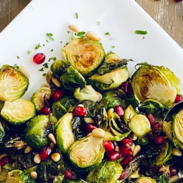 platter of roasted Brussels sprouts with pomegranate and pine nuts