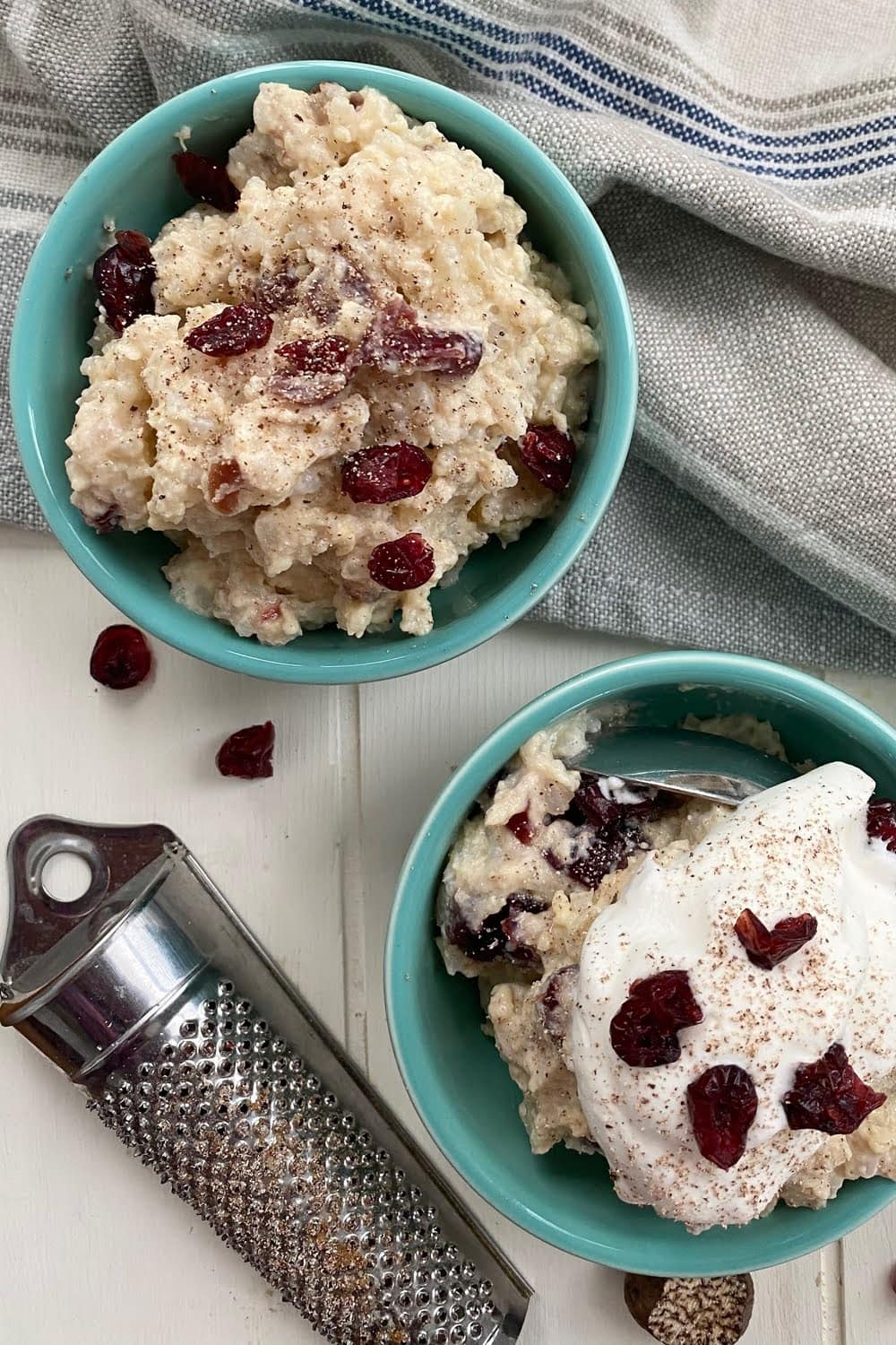 2 bowls of rice pudding - 1 topped with whipped cream