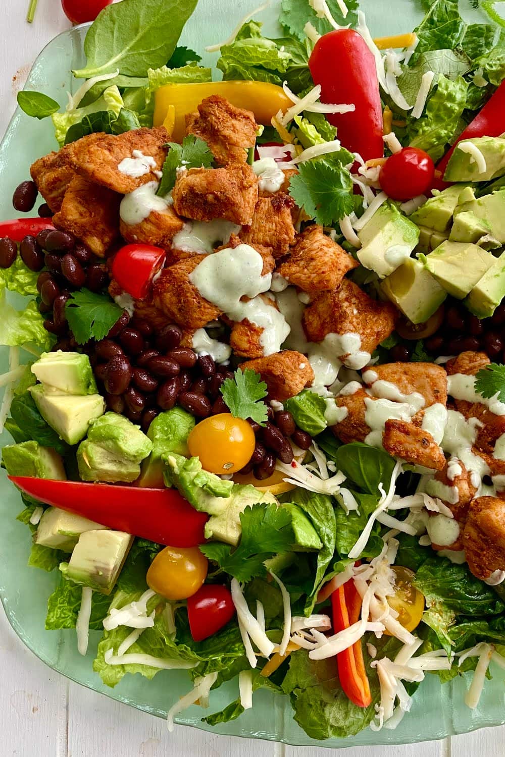 a delicious southwest salad with chicken, avocado, pepper jack cheese and black beans