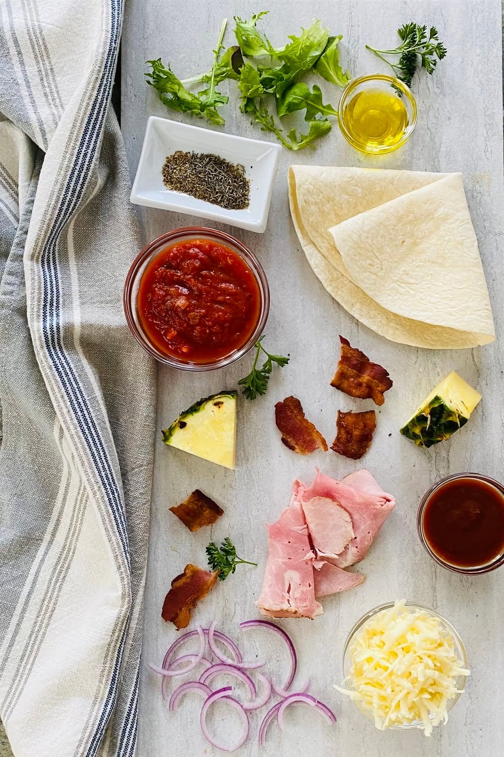 ingredients for tortilla pizza - cheese- marinara-pineapple-ham-bacon-tortillas-cheese