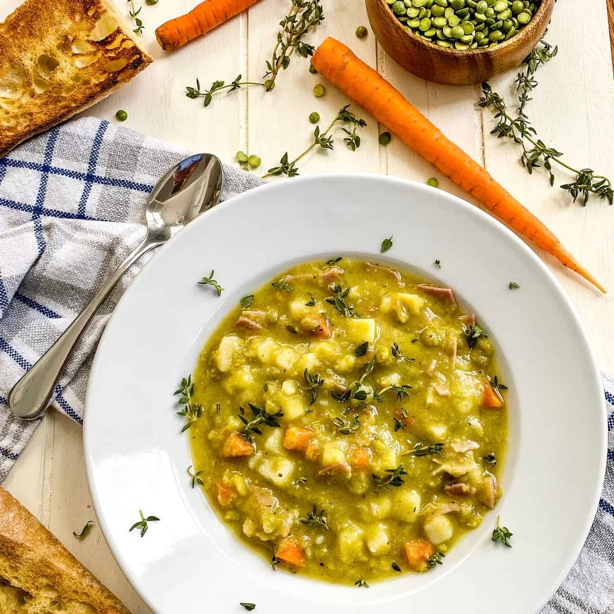 A bowl of split pea soup with a napkin.