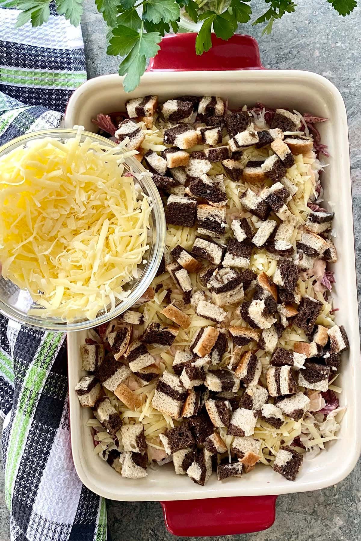 Swiss cheese, cubes of marble rye bread for a layered reuben casserole