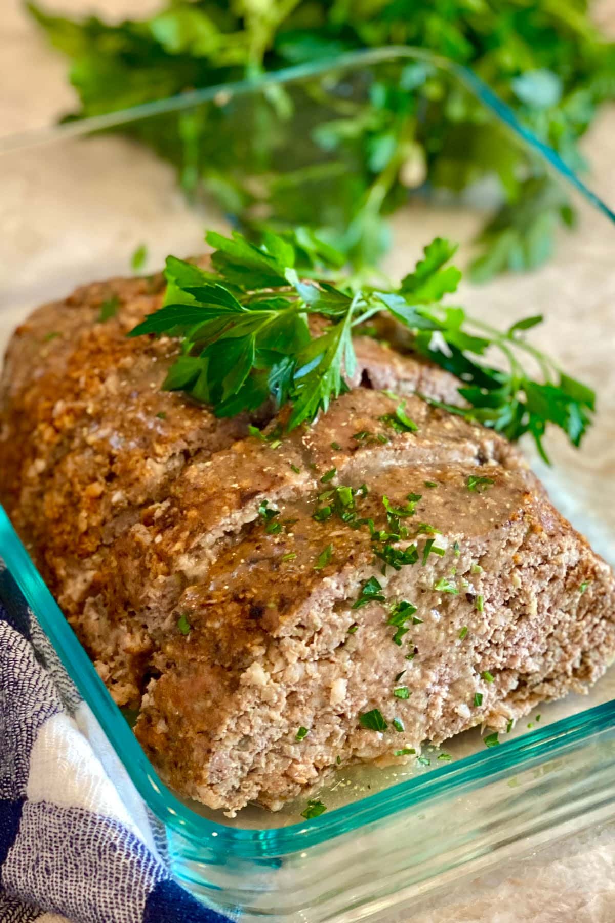 A turkey meatloaf with mushrooms sliced and stored in a glass container.