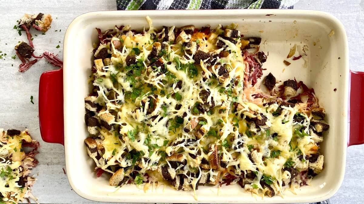 A corned beef casserole with a piece cut out of it.