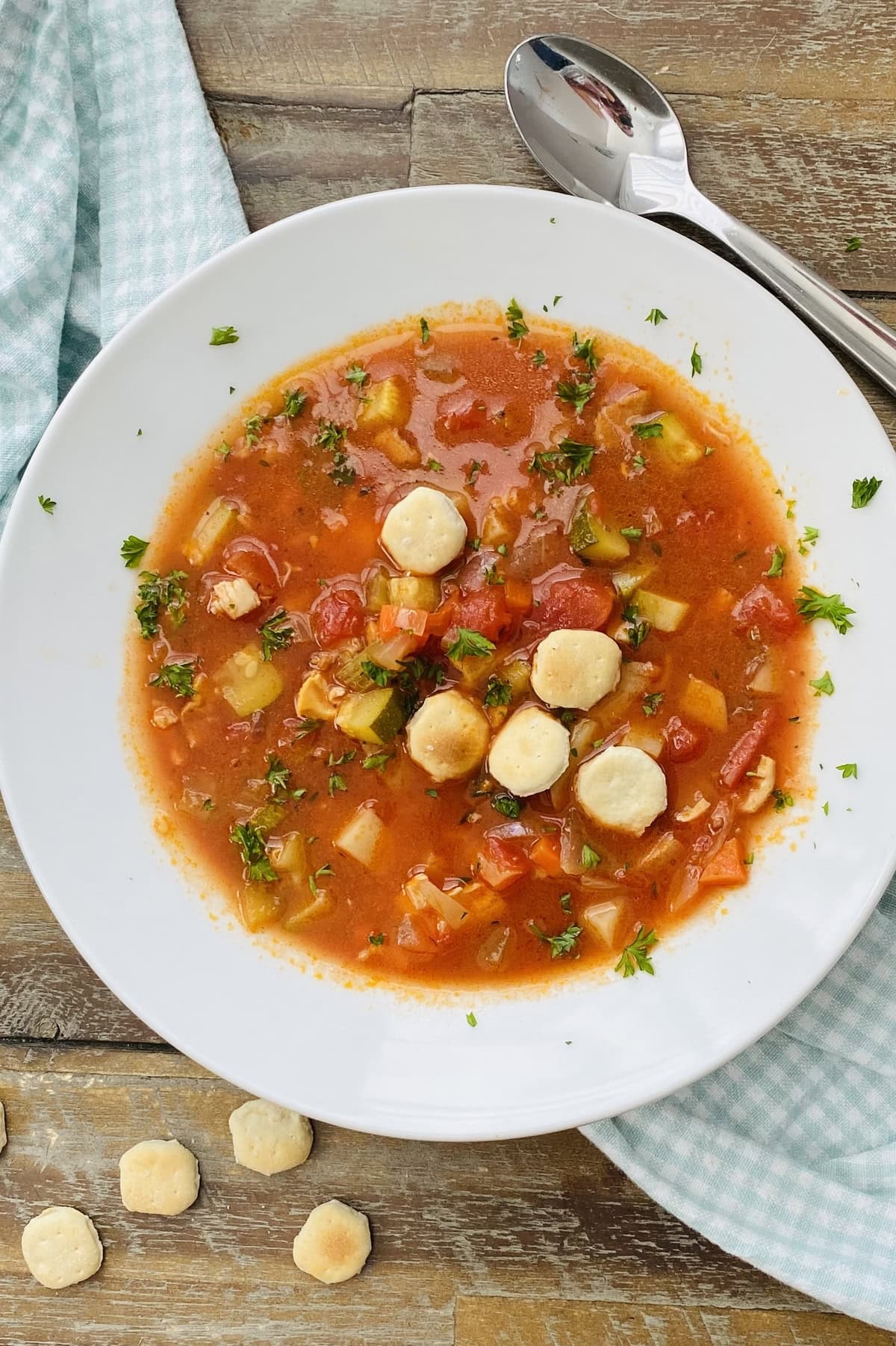 Manhattan clam chowder recipe that's served in a bowl with oyster crackers.