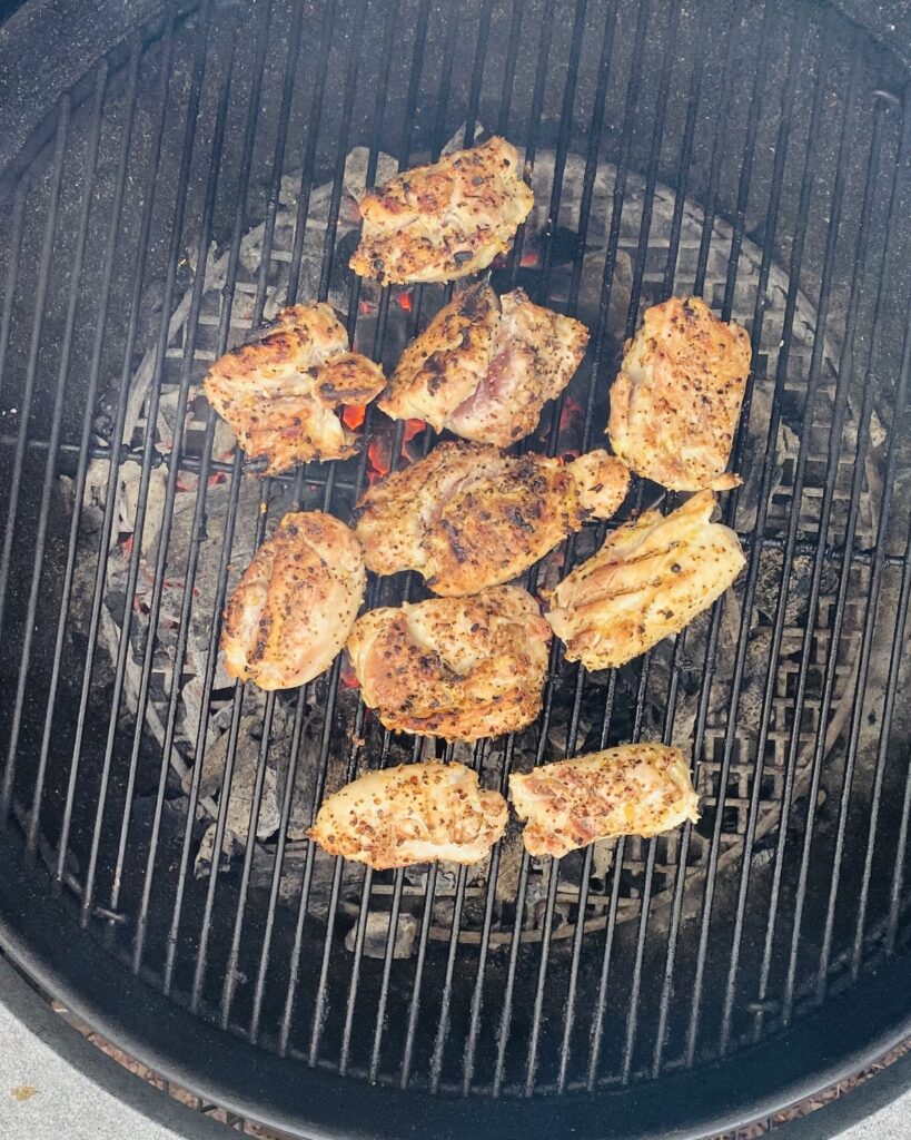 chicken thighs grilling on a Weber grill