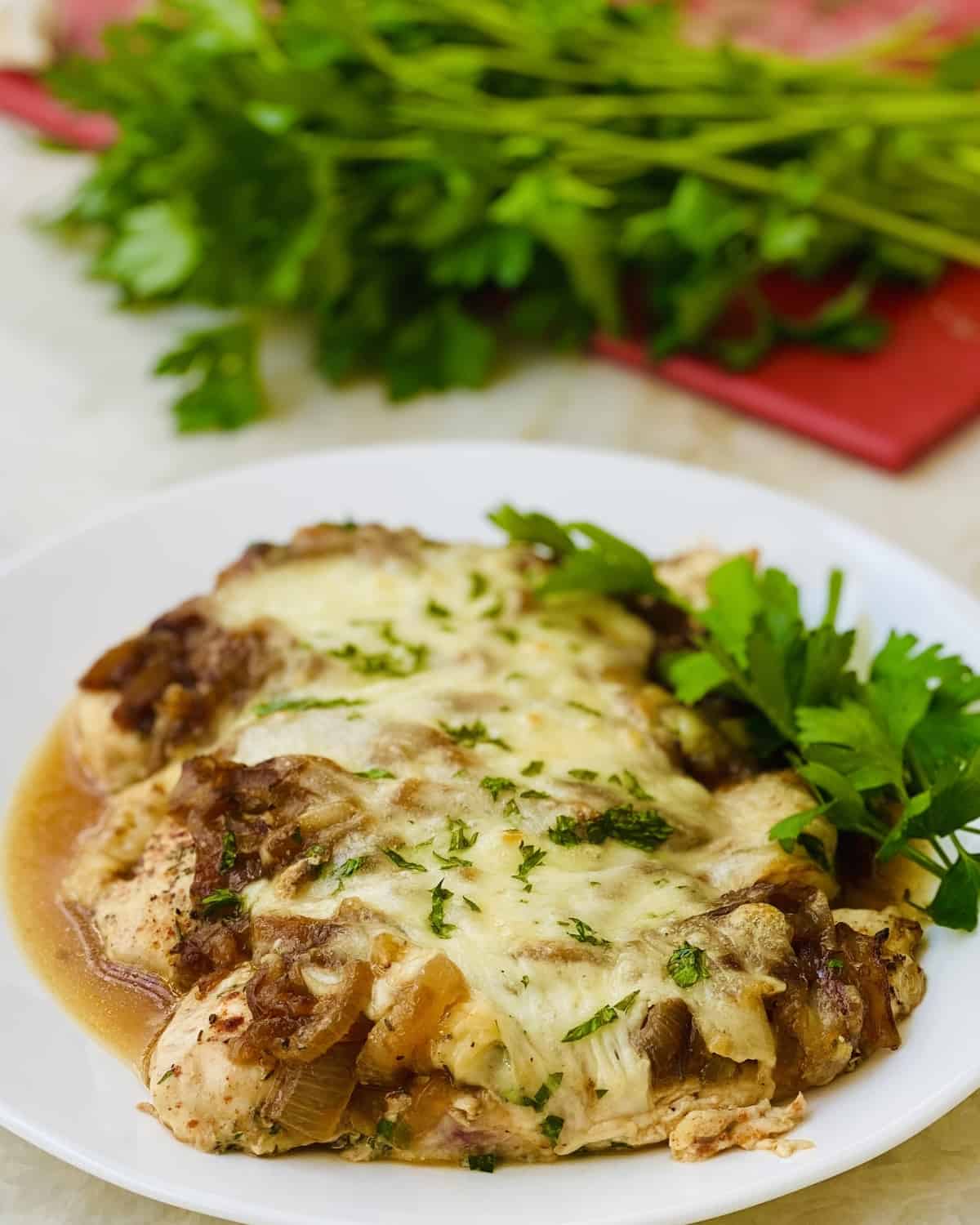 baked chicken topped with caramelized onion and melted cheese