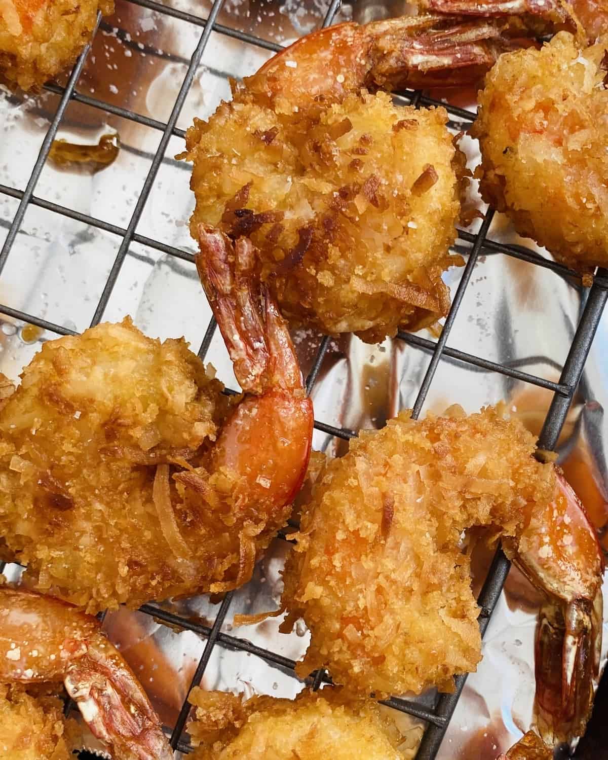 crispy coconut shrimp on a cooling rack