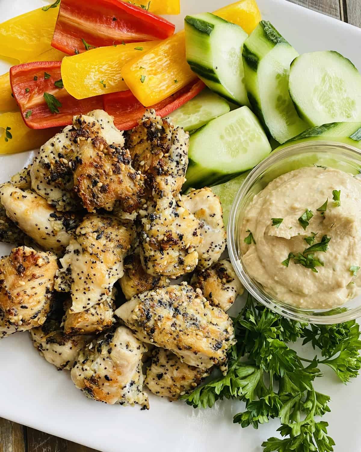 chicken seasoned with everything bagel spice mix with hummus, cucumber and bell peppers