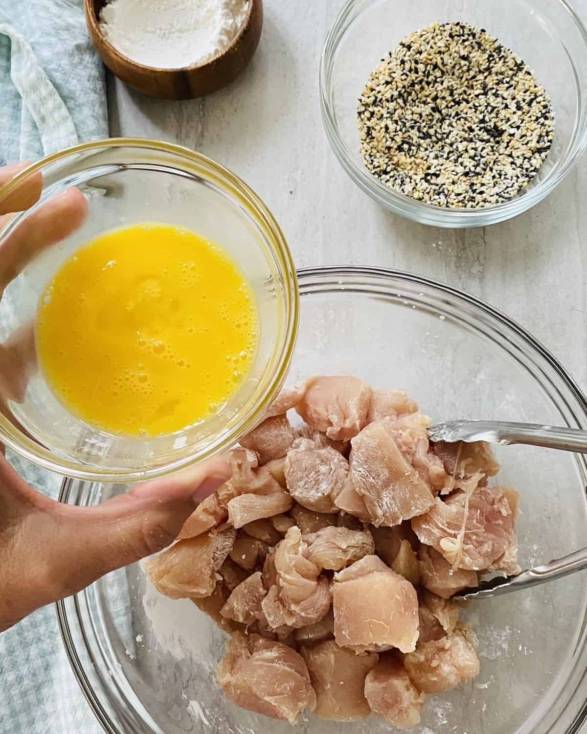 adding beaten egg to chicken pieces
